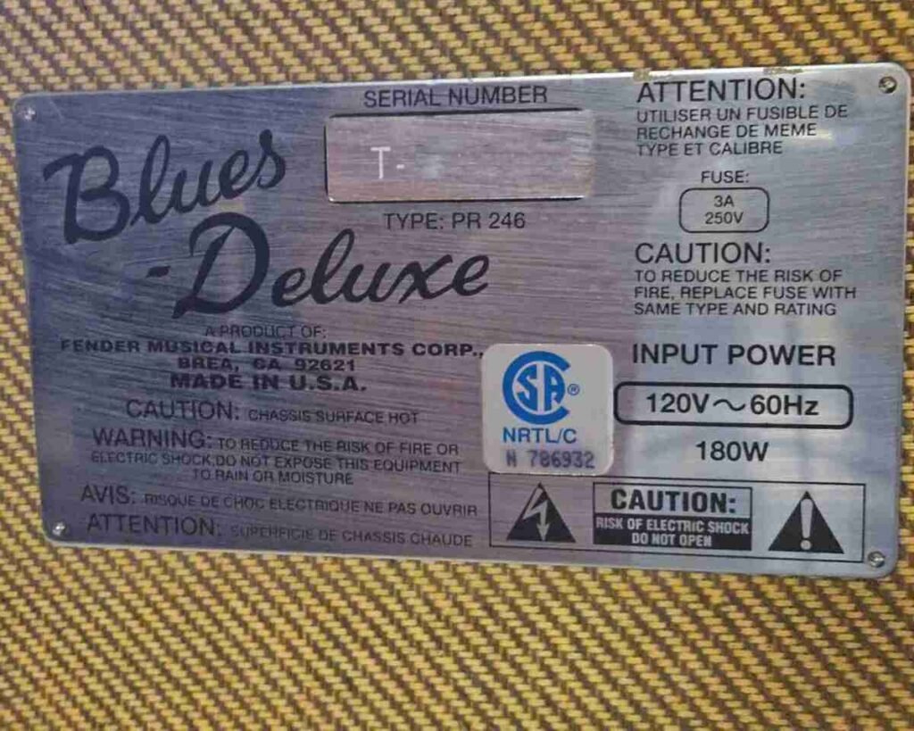 Roland Cube 60 front (original photo) — Roland Cube 60 centered, metal grille and Roland logo visible, coiled cable resting on top, no front knobs.