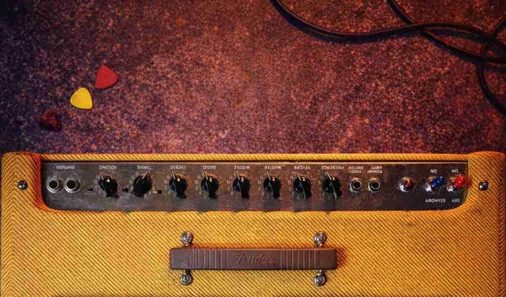 Roland Cube 60 on stage (1200×1200) — Same Cube 60 centered in a 1200×1200 square on a gritty concert stage with haze and colored lights; amp is focal point.