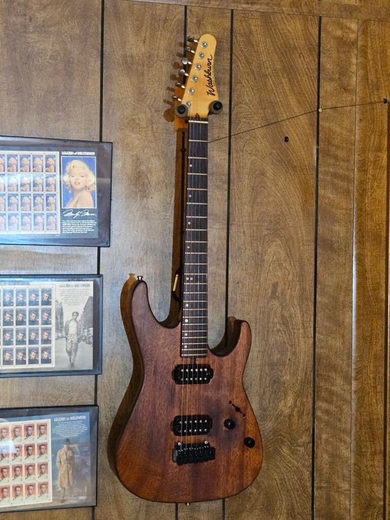 Full-body photo of the Woody electric guitar showing its padauk wood grain and hardware.