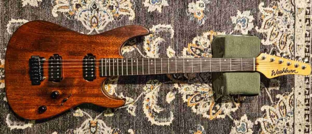 Woody the 1994 Chicago Custom Shop Washburn guitar with rare solid Padauk body, resting on a stand — the lifelong companion at the heart of this story